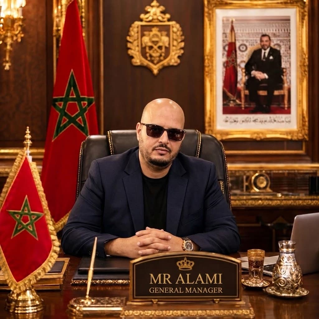 Mr. Alami, wearing sunglasses, sits at a desk with Moroccan flags and a royal portrait.